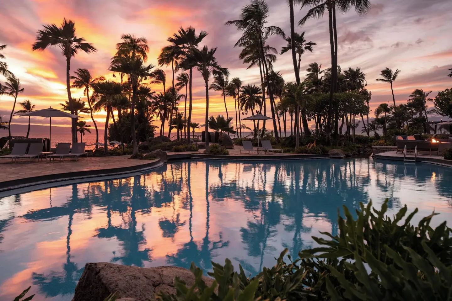 Sunset reflects in the palm-lined pool at The Westin Maui Resort & Spa, Ka'anapali.