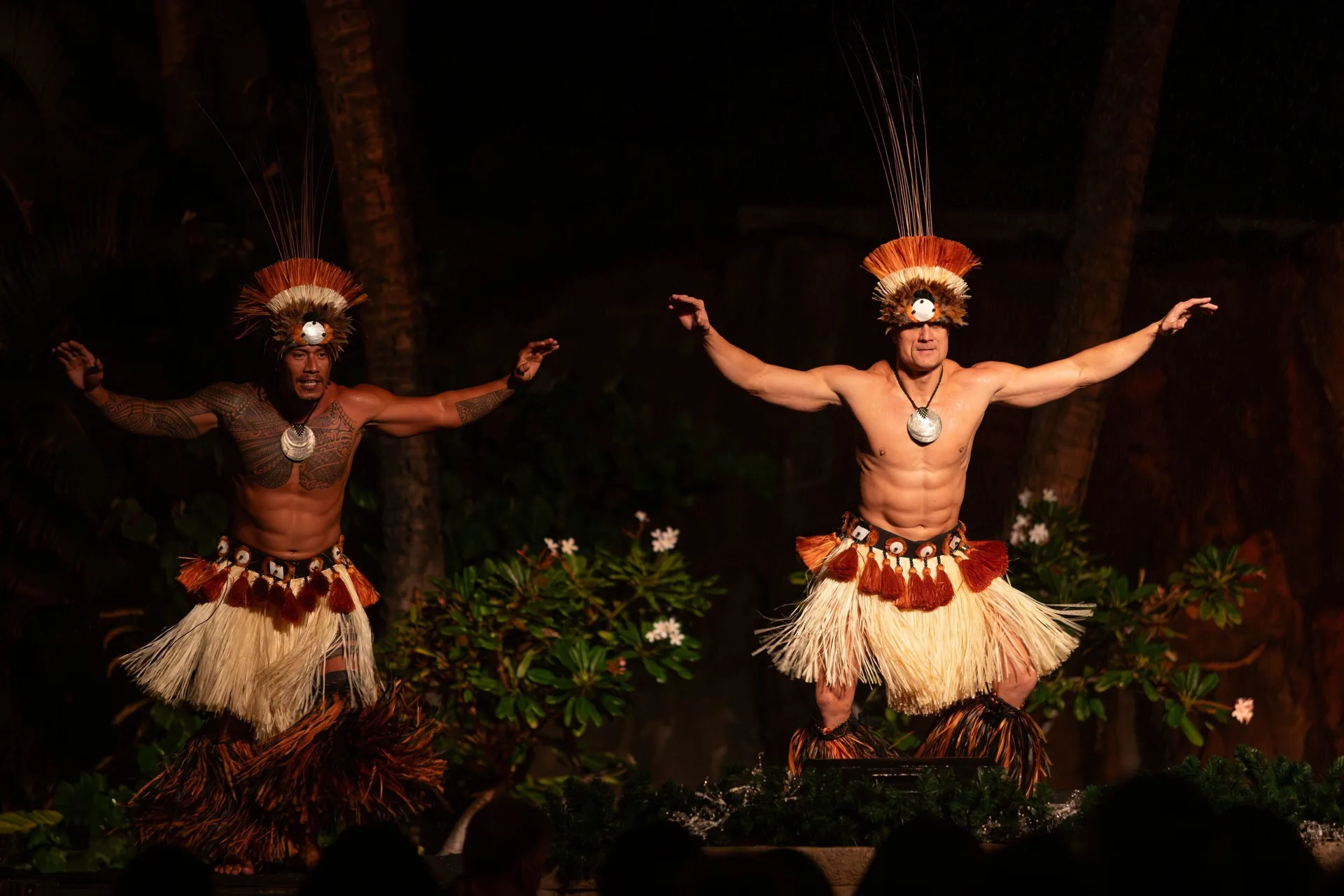 Two male luau dancers perform on an outdoor stage at The Westin Maui Resort & Spa, Ka'anapali.