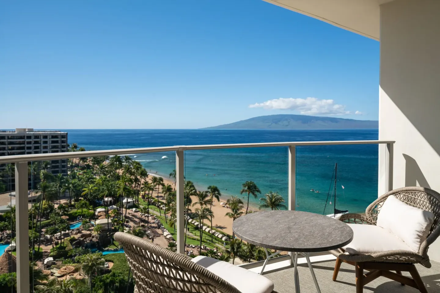 Ocean-view balcony seating at The Westin Maui Resort & Spa, Ka'anapali overlooking beach and pools.