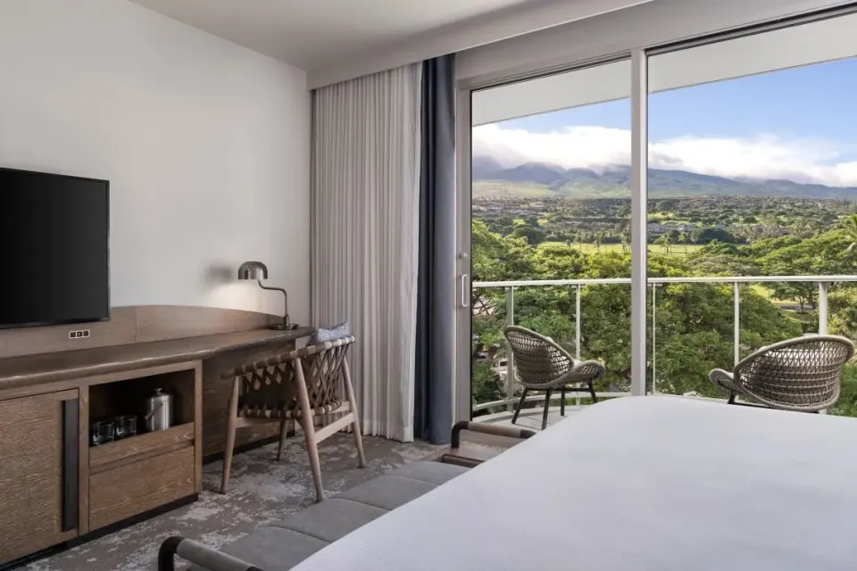 Desk, TV, king bed, and balcony view in a guest room at The Westin Maui Resort & Spa, Ka'anapali.