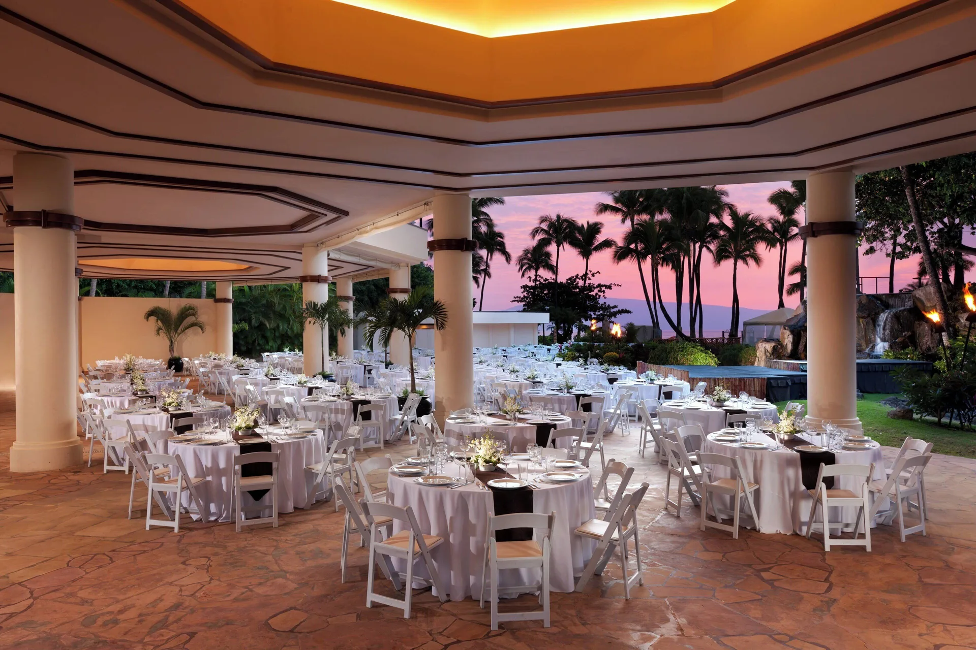 Outdoor wedding reception setup at The Westin Maui Resort & Spa, Ka'anapali with round tables at sunset.