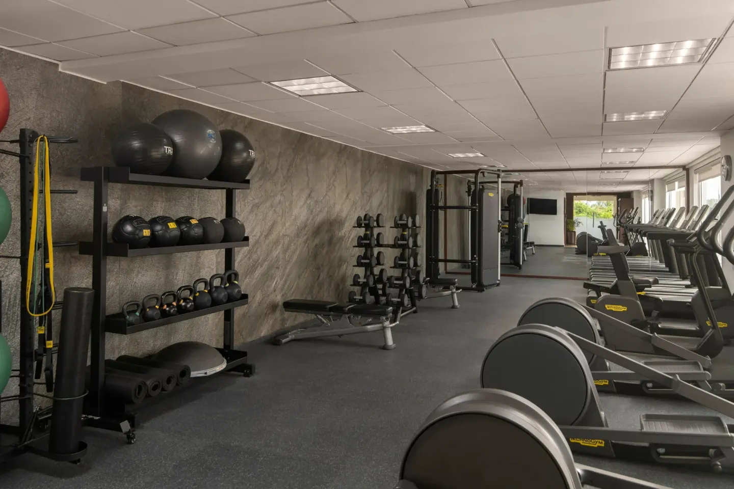 Fitness center free weights, exercise balls, and cardio machines at The Westin Puntacana Resort.