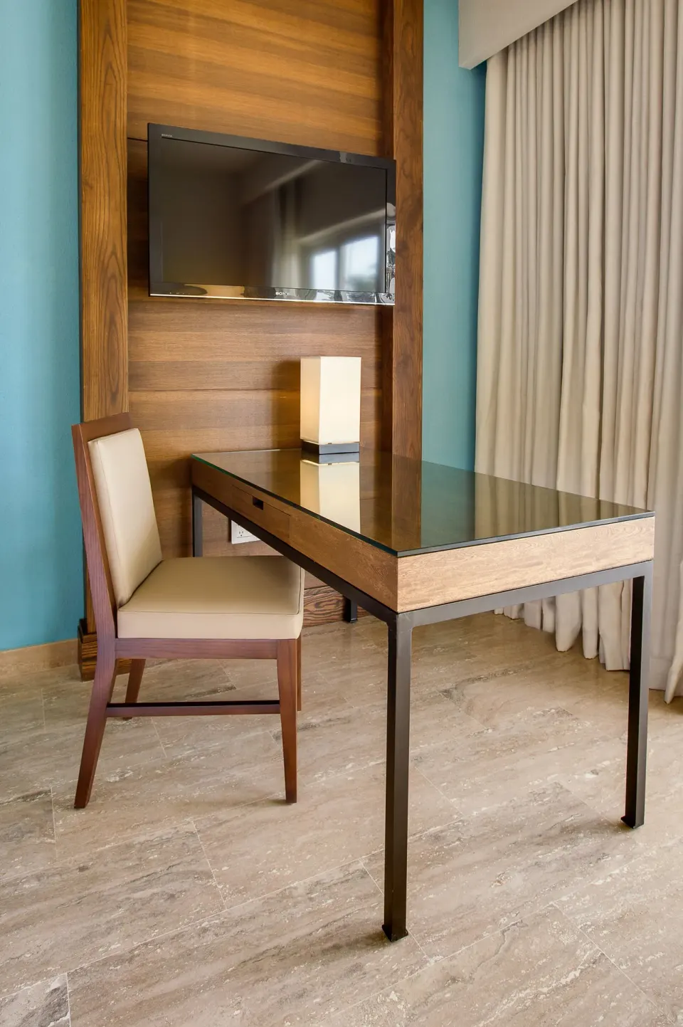 Guest room desk, chair, and wall-mounted TV at The Westin Puntacana Resort.