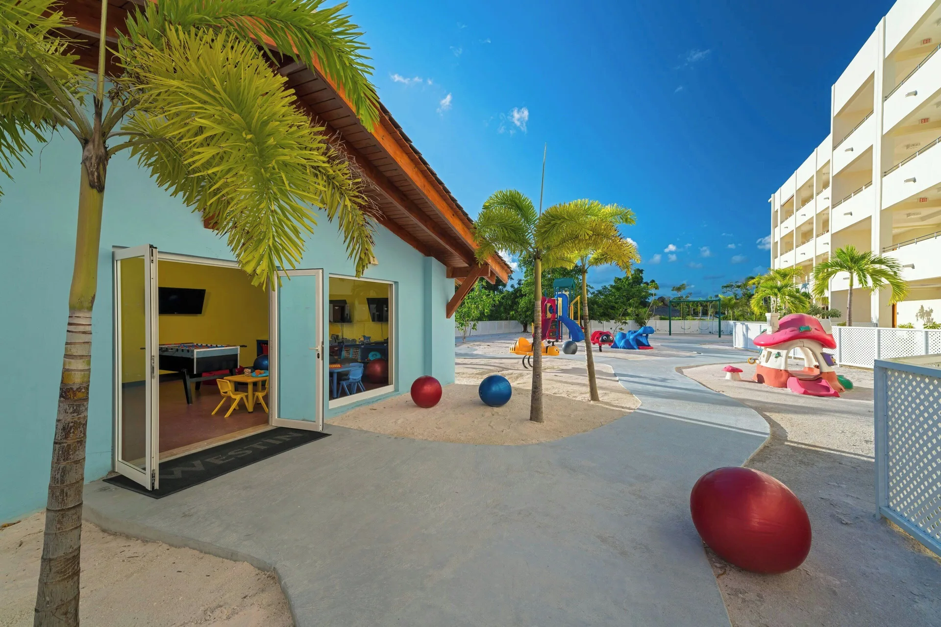 Kids club building and colorful outdoor play area at The Westin Puntacana Resort.