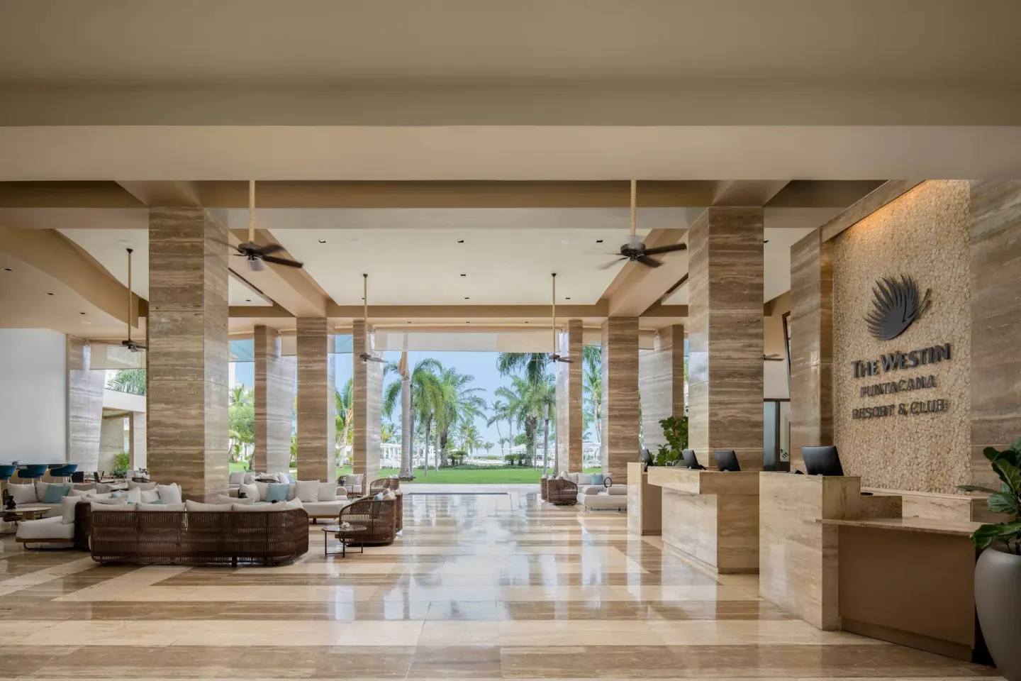 Open-air lobby at The Westin Puntacana Resort with reception desks and garden views.