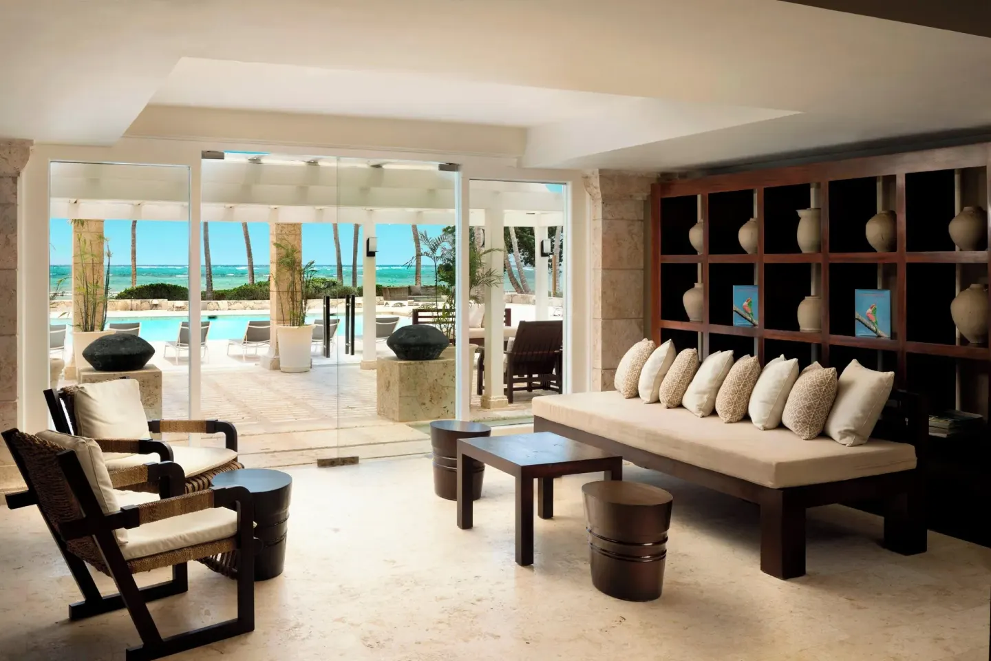Open-air lounge seating with pool and ocean beyond at The Westin Puntacana Resort.