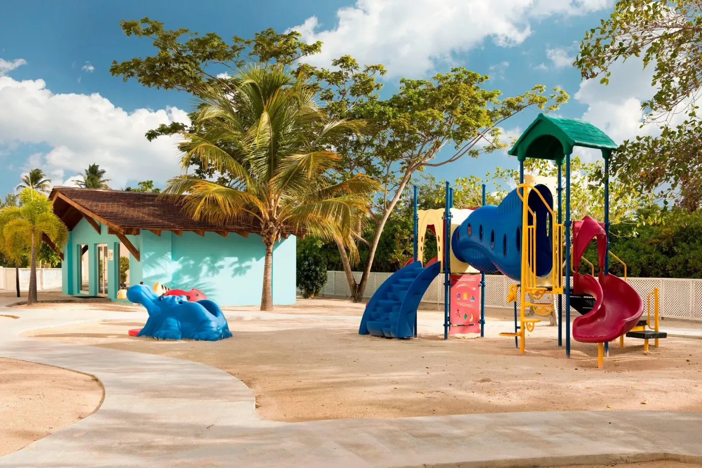 A colorful outdoor playground with slides and a hippo feature at The Westin Puntacana Resort.