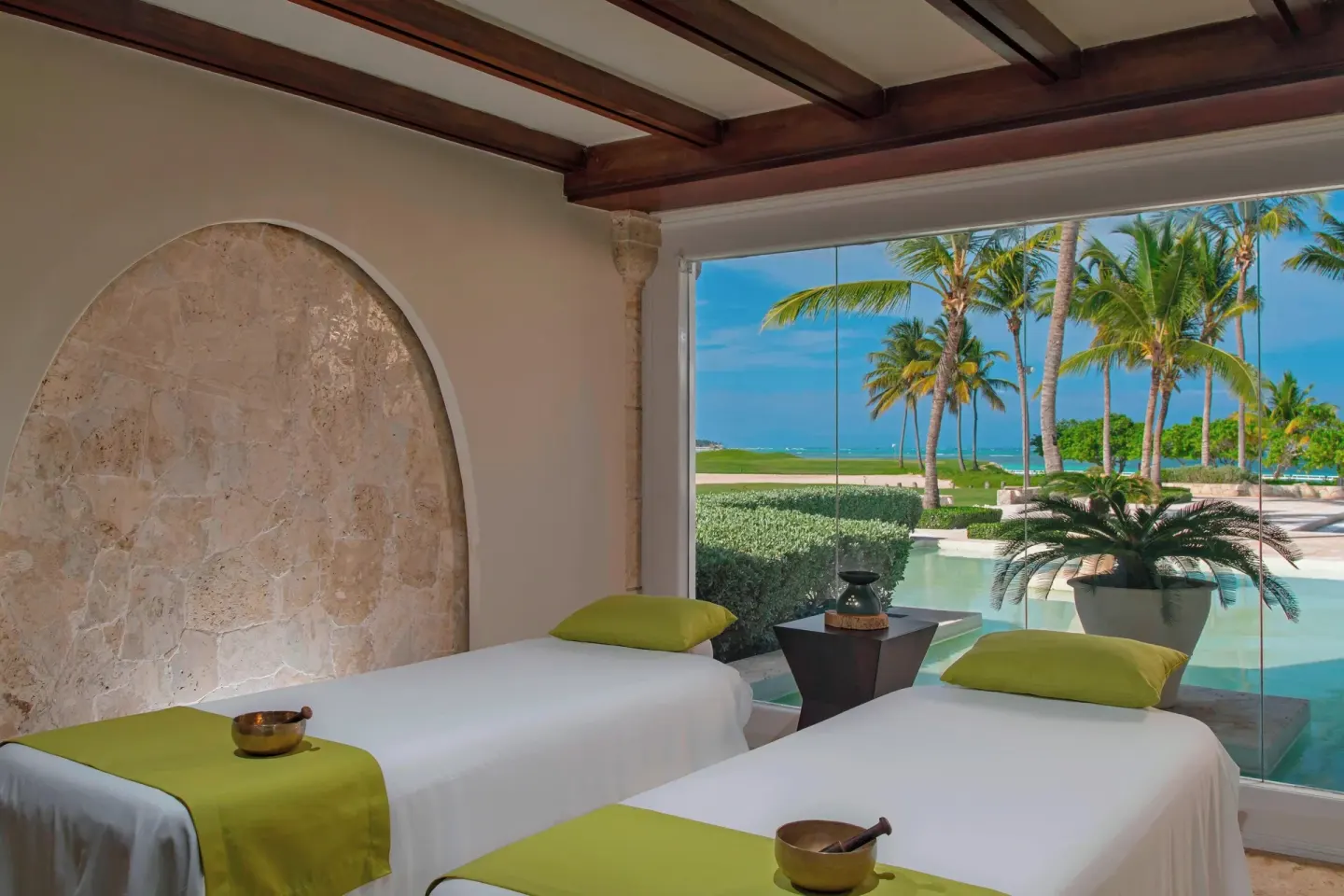 Spa treatment room with two massage tables and ocean view at The Westin Puntacana Resort.