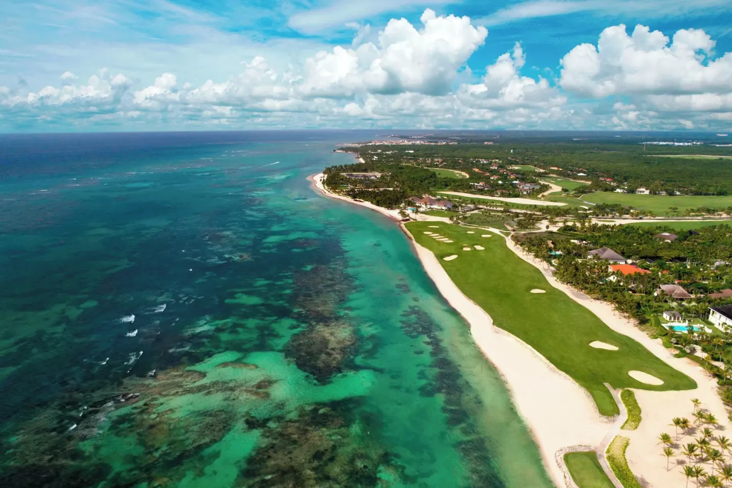 An aerial coastline view shows turquoise water and golf fairways at The Westin Puntacana Resort.
