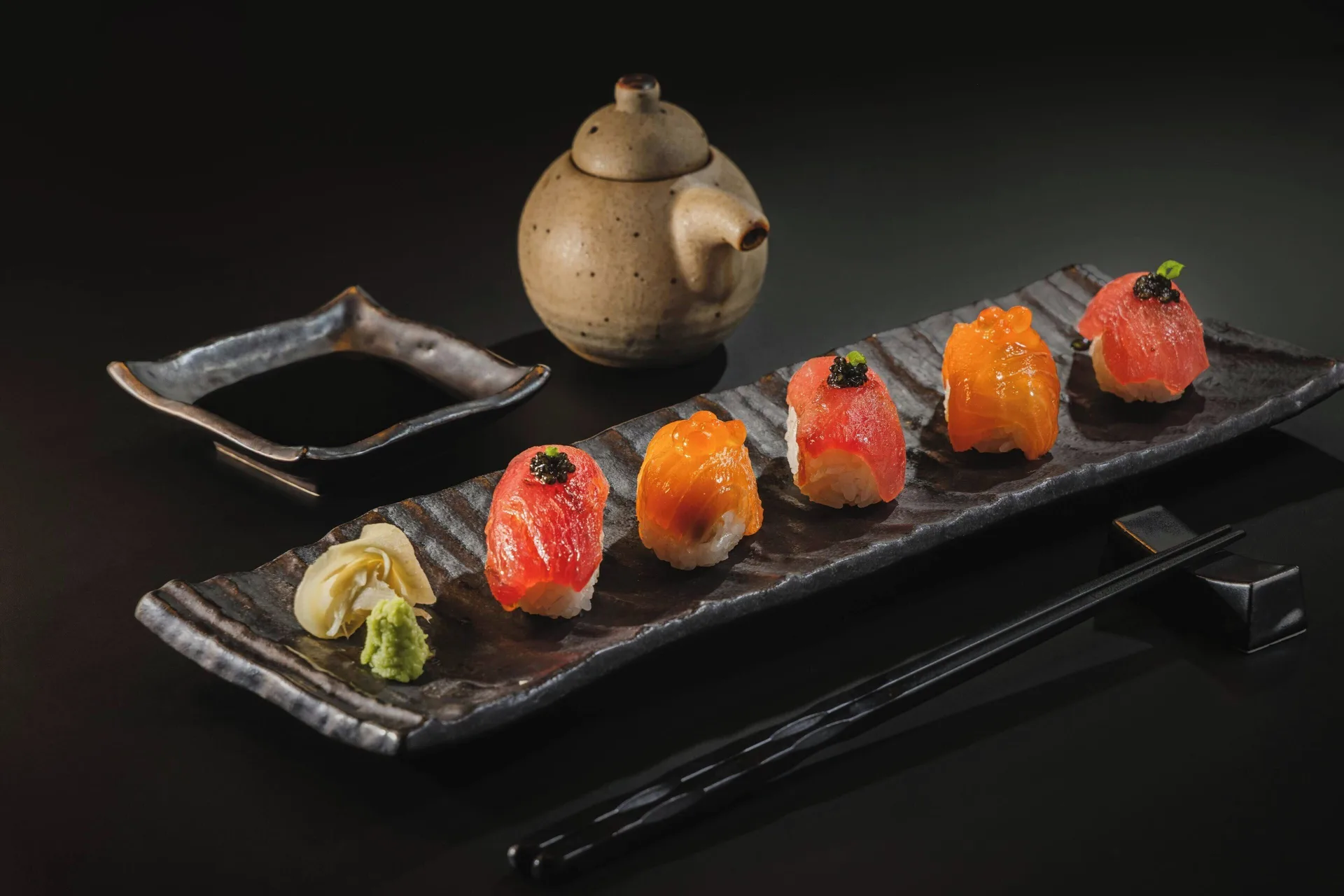 Sushi and tea service on a dark tabletop at The Westin Puntacana Resort.