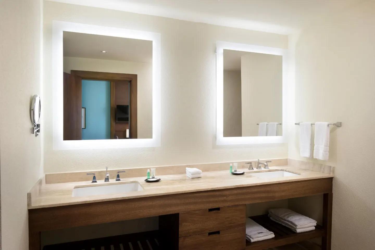 Premium Room bathroom vanity with two sinks and illuminated mirrors at The Westin Puntacana Resort.
