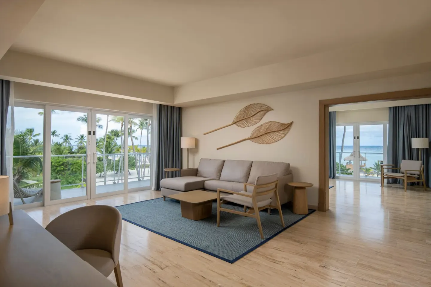One-bedroom suite living room with sofa and ocean-view bedroom beyond at The Westin Puntacana Resort.