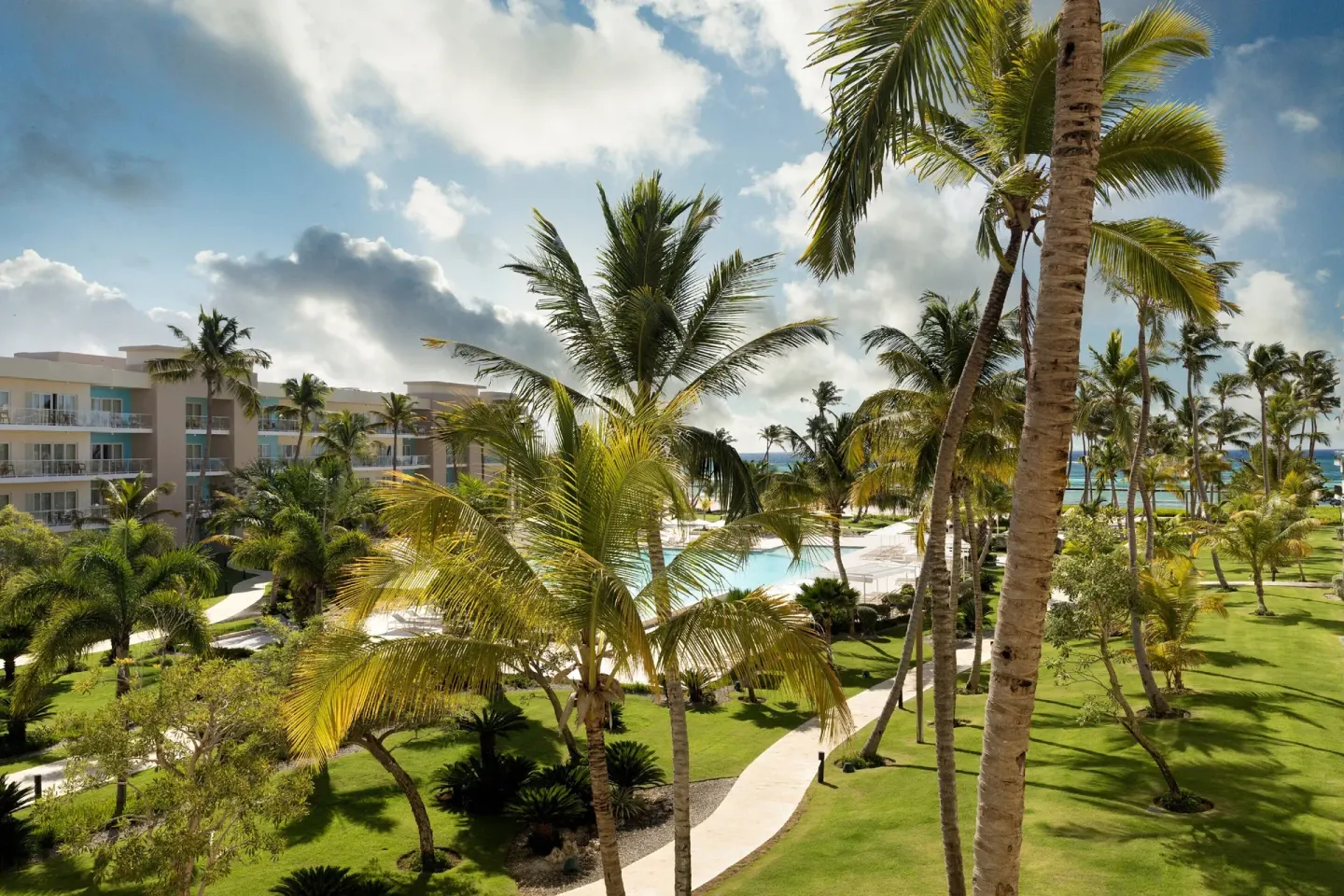 Ocean-view balcony outlook from a suite at The Westin Puntacana Resort with palms, pool, and beach.