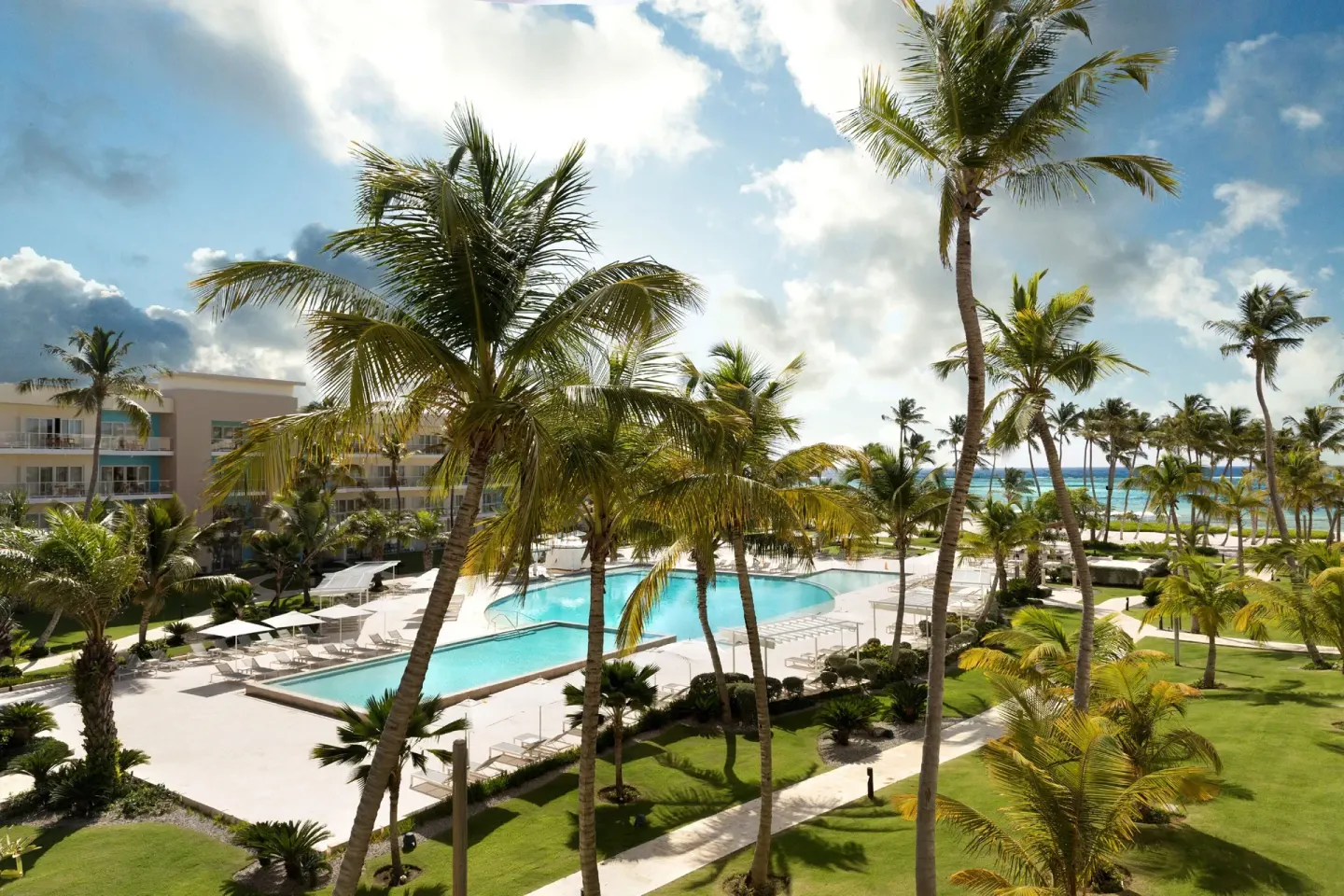 Ocean-view room outlook over the pool, palms and beach at The Westin Puntacana Resort.