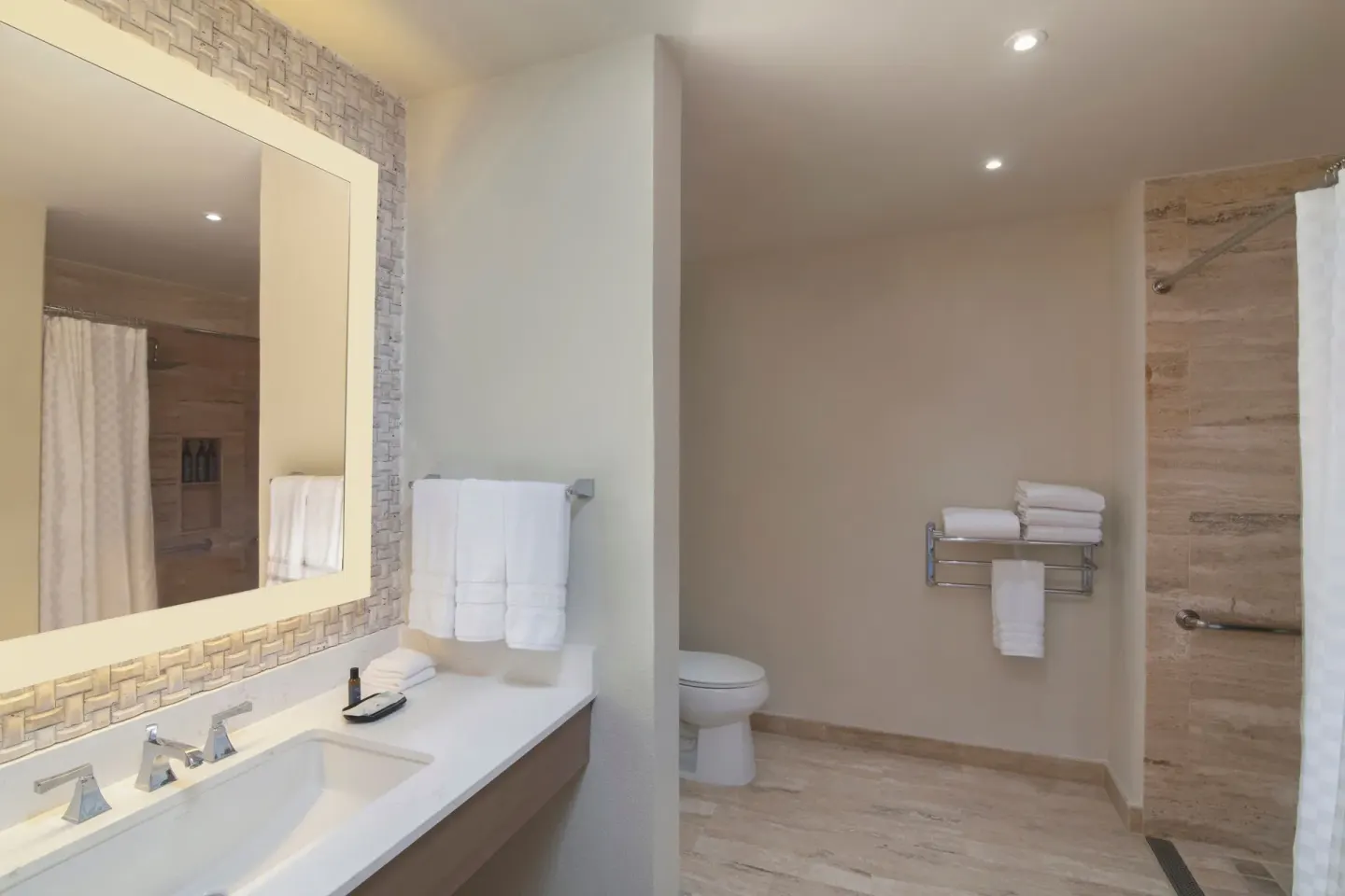 Traditional Room Ocean View bathroom vanity, mirror, toilet, and shower at The Westin Puntacana Resort.