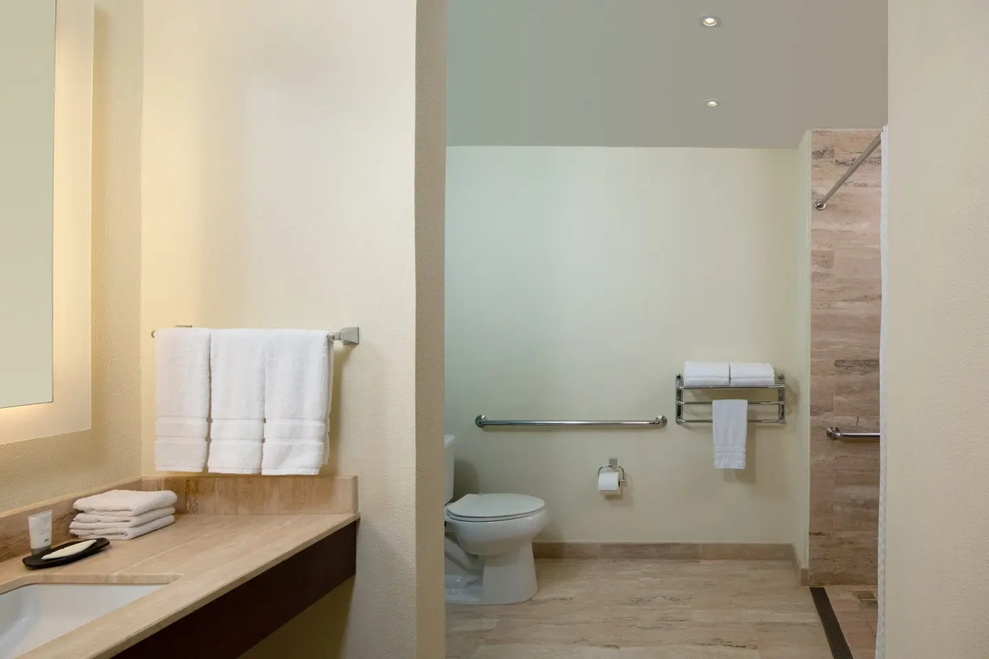 Traditional Room Ocean View bathroom with vanity, toilet, shower, and towels at The Westin Puntacana Resort.