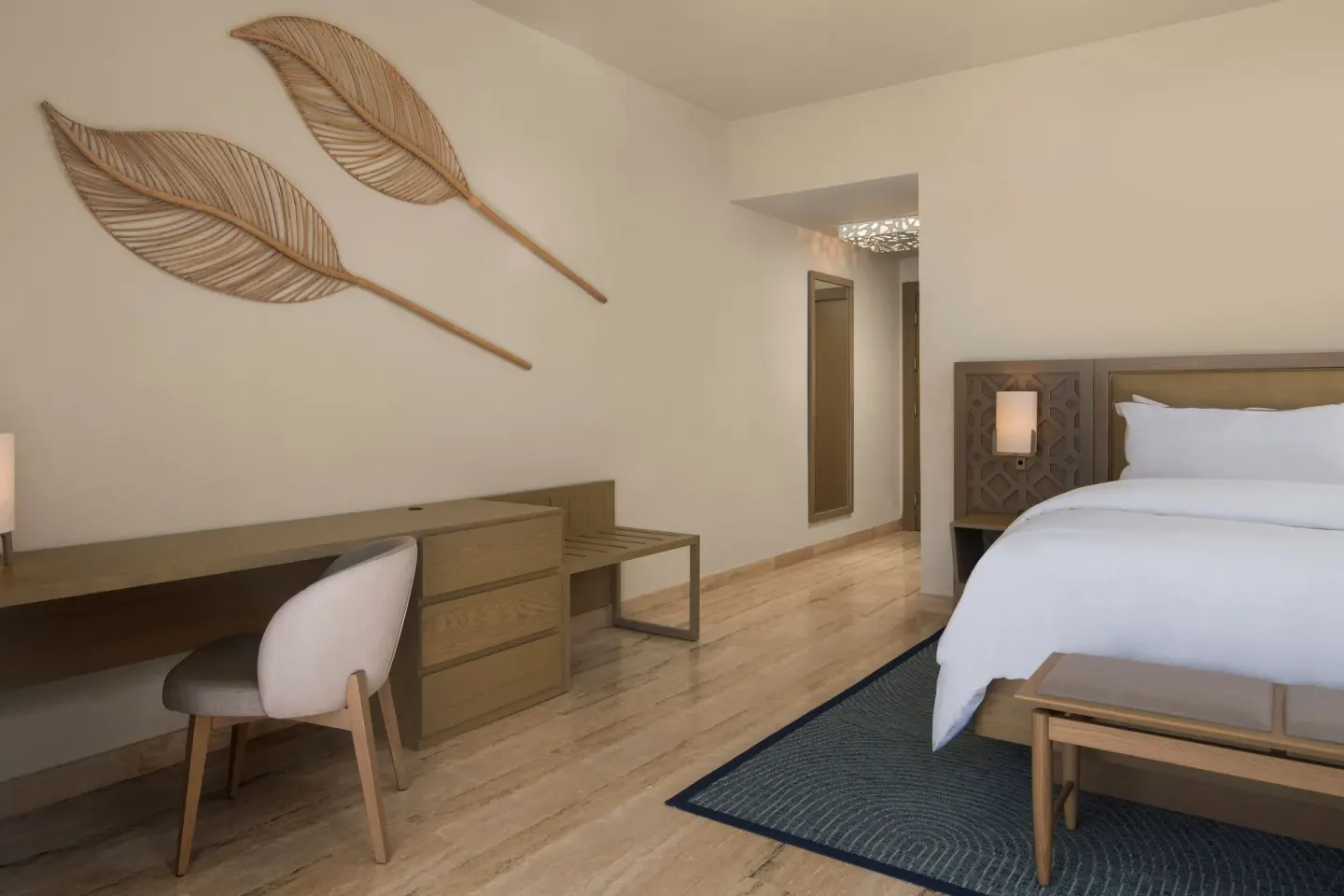 Traditional Room king bed with desk and leaf wall decor at The Westin Puntacana Resort.