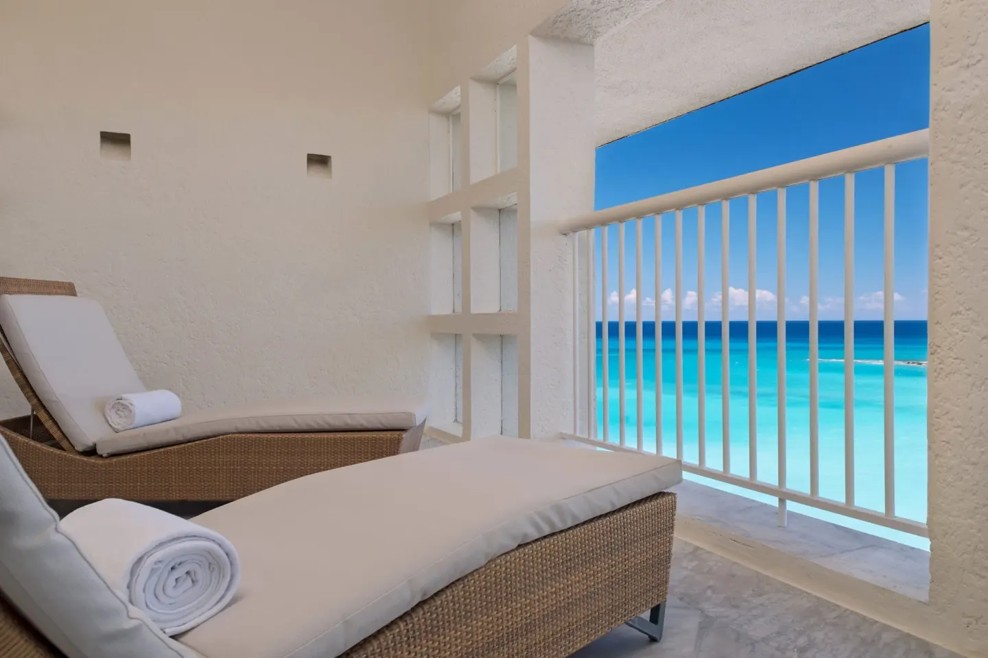 Balcony lounge chairs overlooking the Caribbean Sea at The Westin Resort & Spa, Cancun.