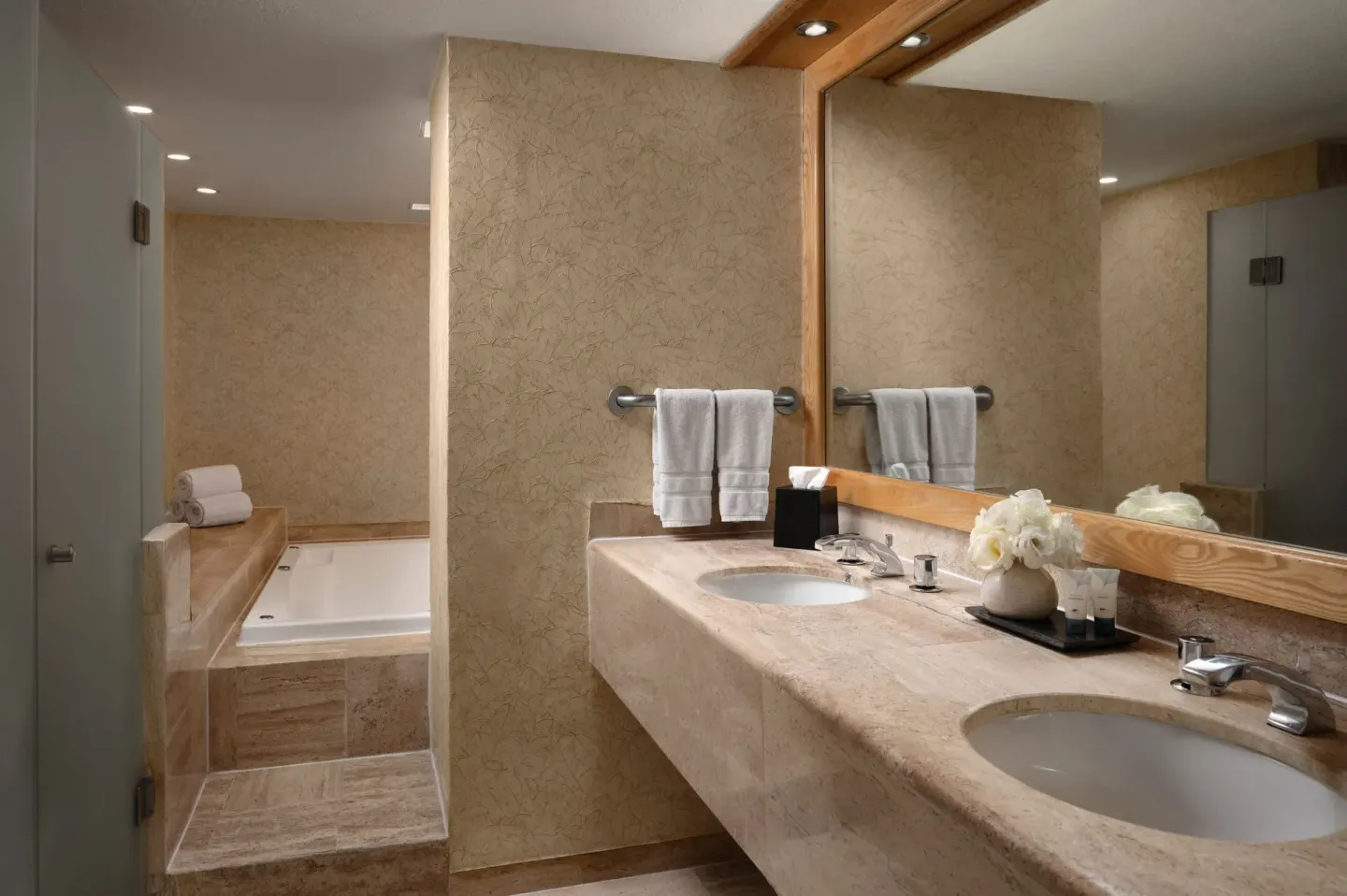 Double-sink bathroom with tub and glass shower at The Westin Resort & Spa, Cancun.