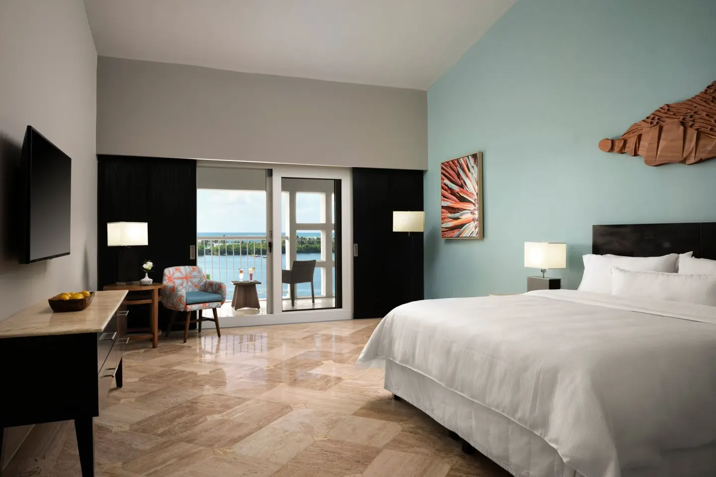Guest room with king bed and balcony view at The Westin Resort & Spa, Cancun.