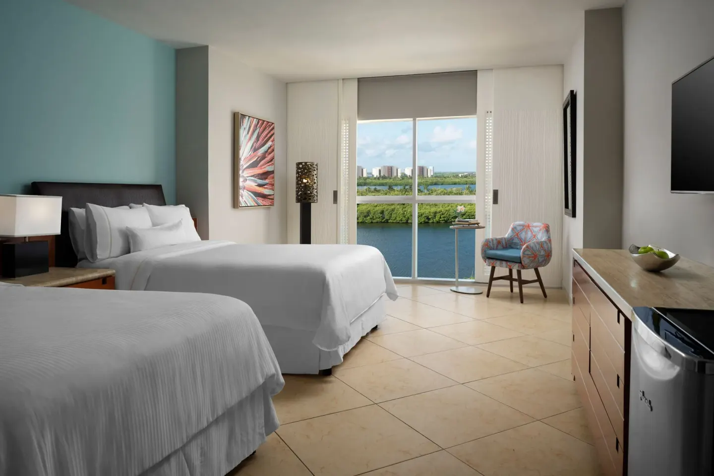 Guest room with two beds and lagoon-facing window at The Westin Resort & Spa, Cancun.