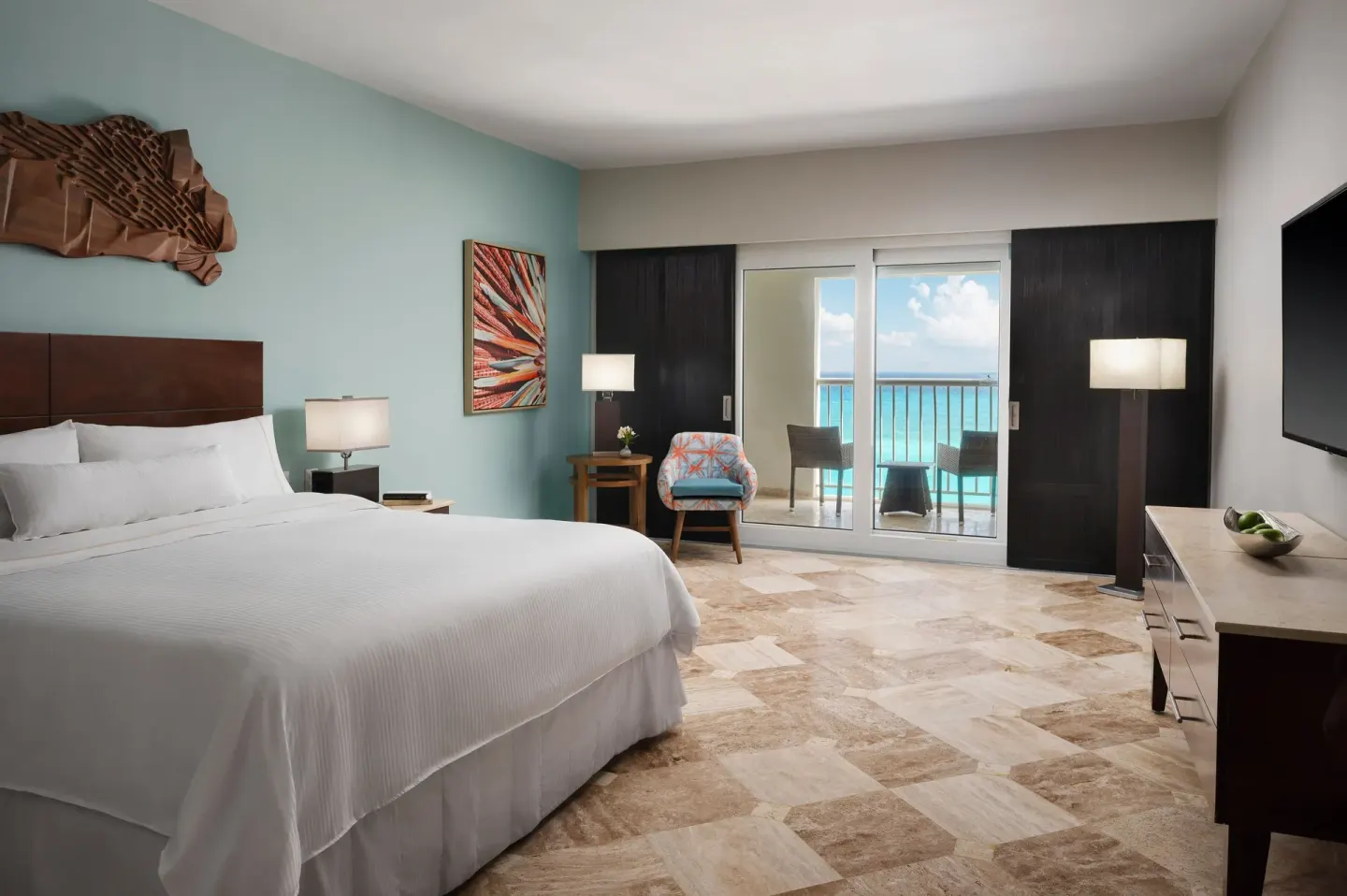 Guest room with king bed, balcony, and ocean view at The Westin Resort & Spa, Cancun.