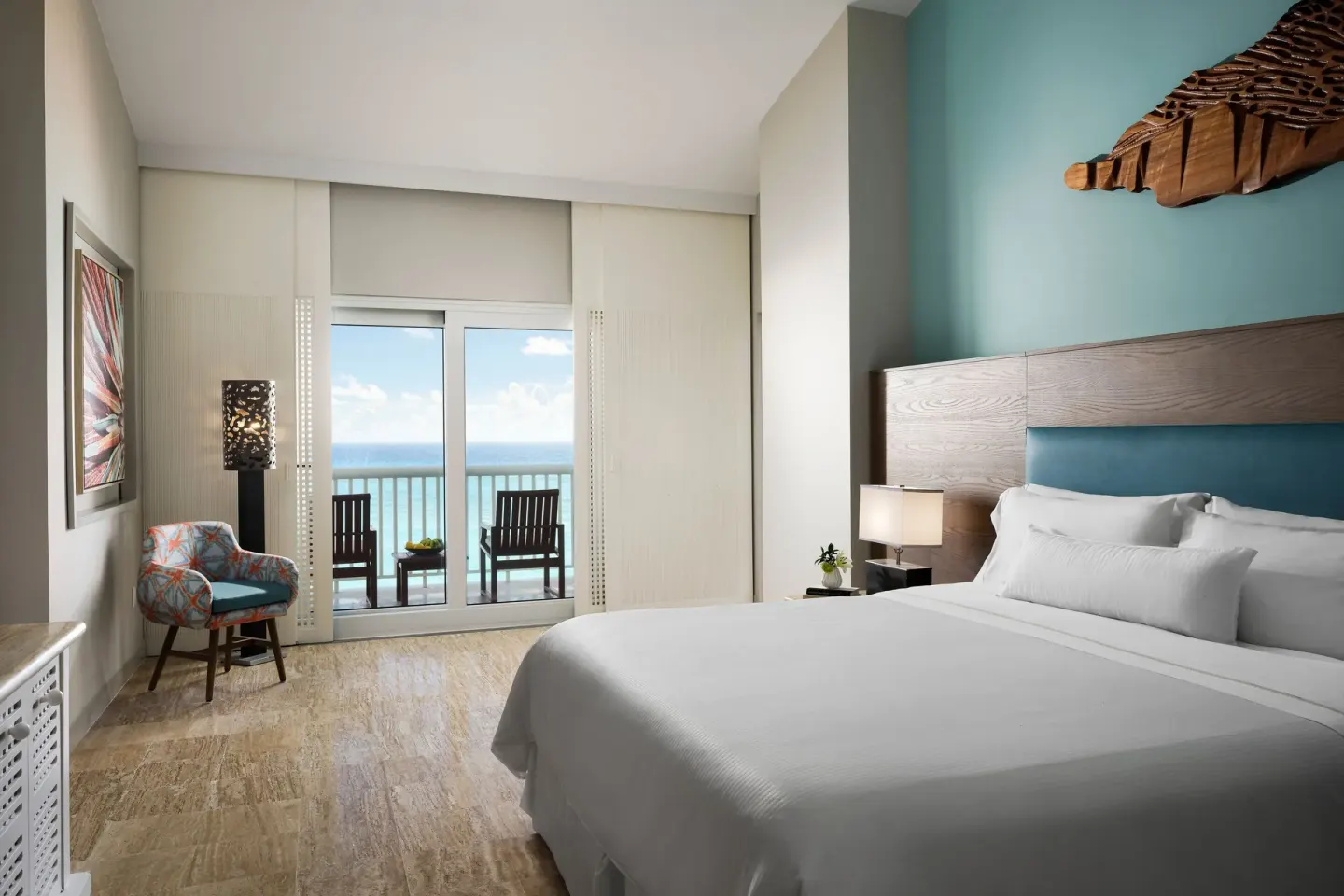 King guest room with balcony chairs and ocean view at The Westin Resort & Spa, Cancun.