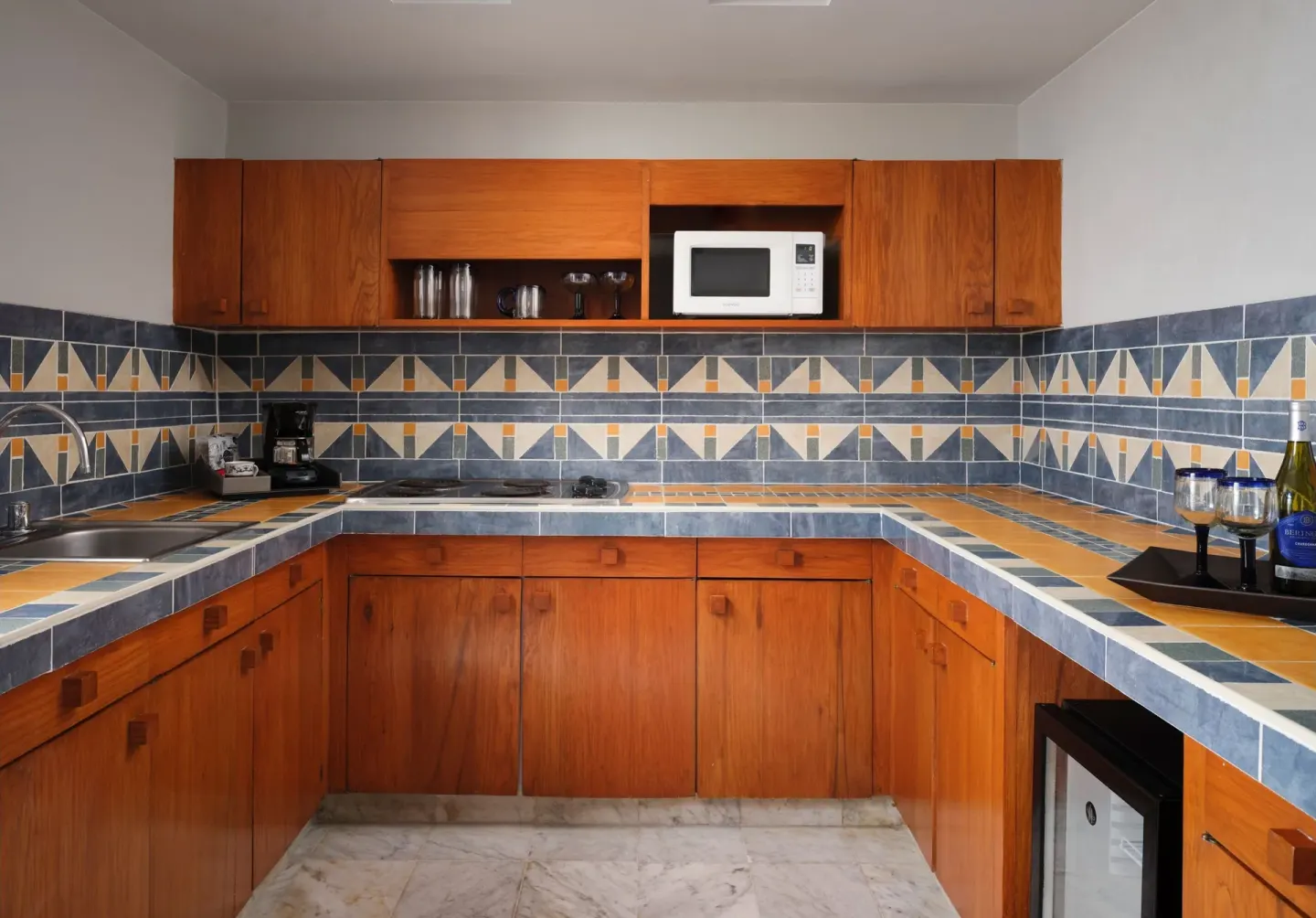 Kitchen with wood cabinets and patterned tile at The Westin Resort & Spa, Cancun.