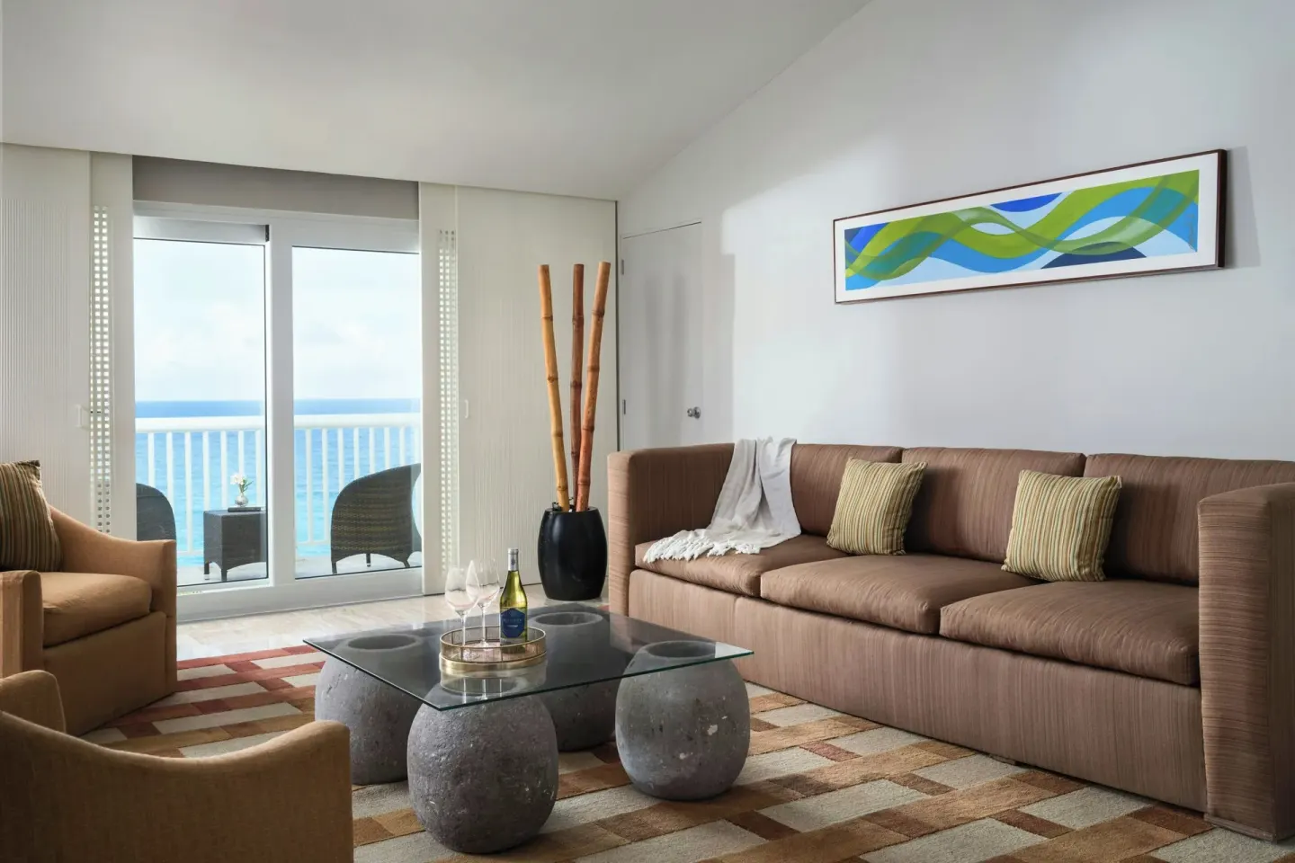 Ocean-view suite living room with sofa and balcony at The Westin Resort & Spa, Cancun.
