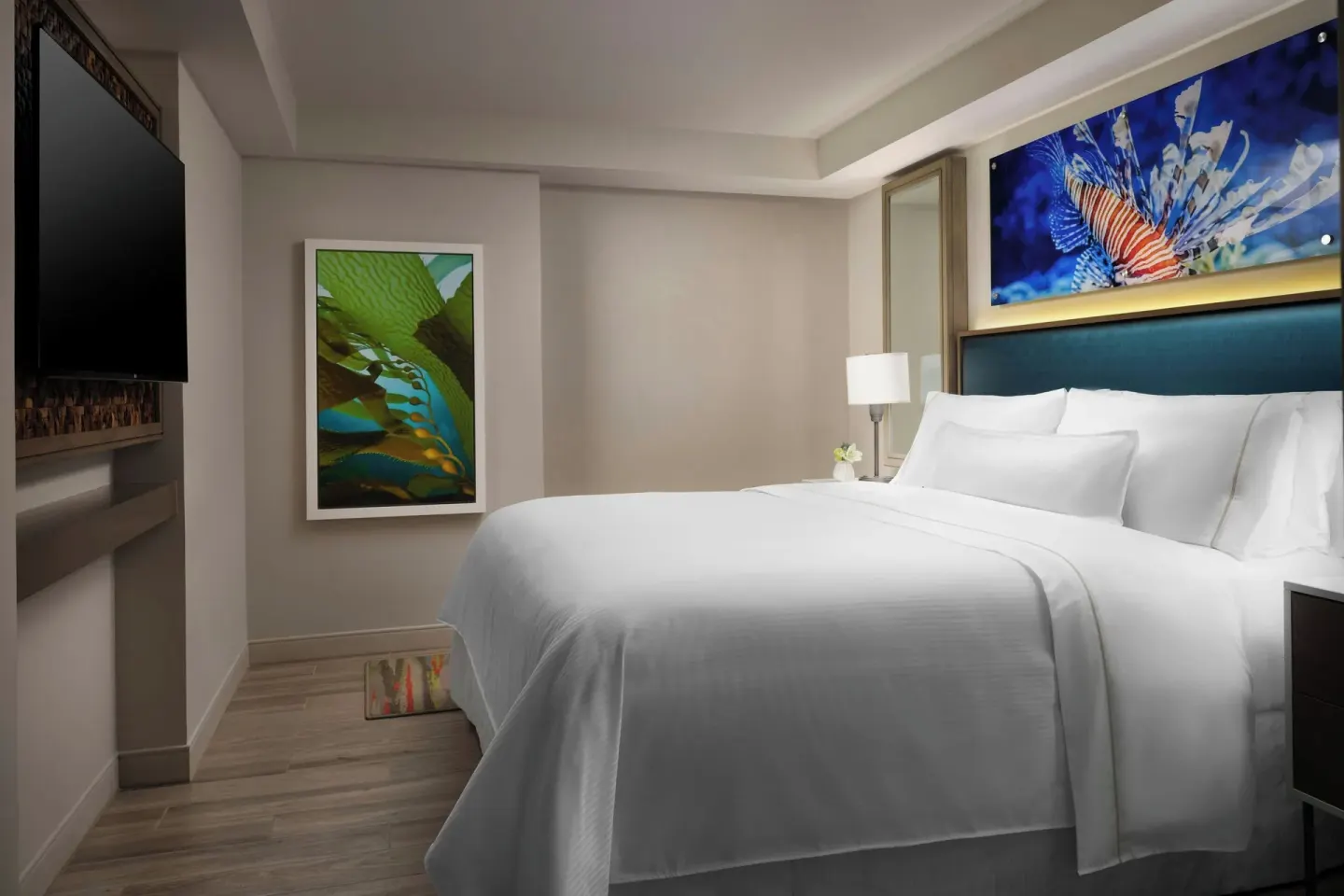 Bedroom with a king bed and wall art in a suite at The Westin Resort & Spa, Cancun.