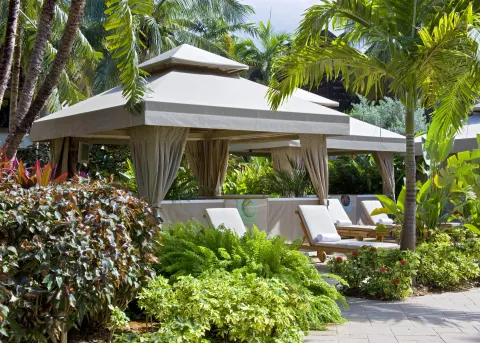 Poolside cabanas with lounge chairs in tropical gardens at The Westin St. John Resort Villas.