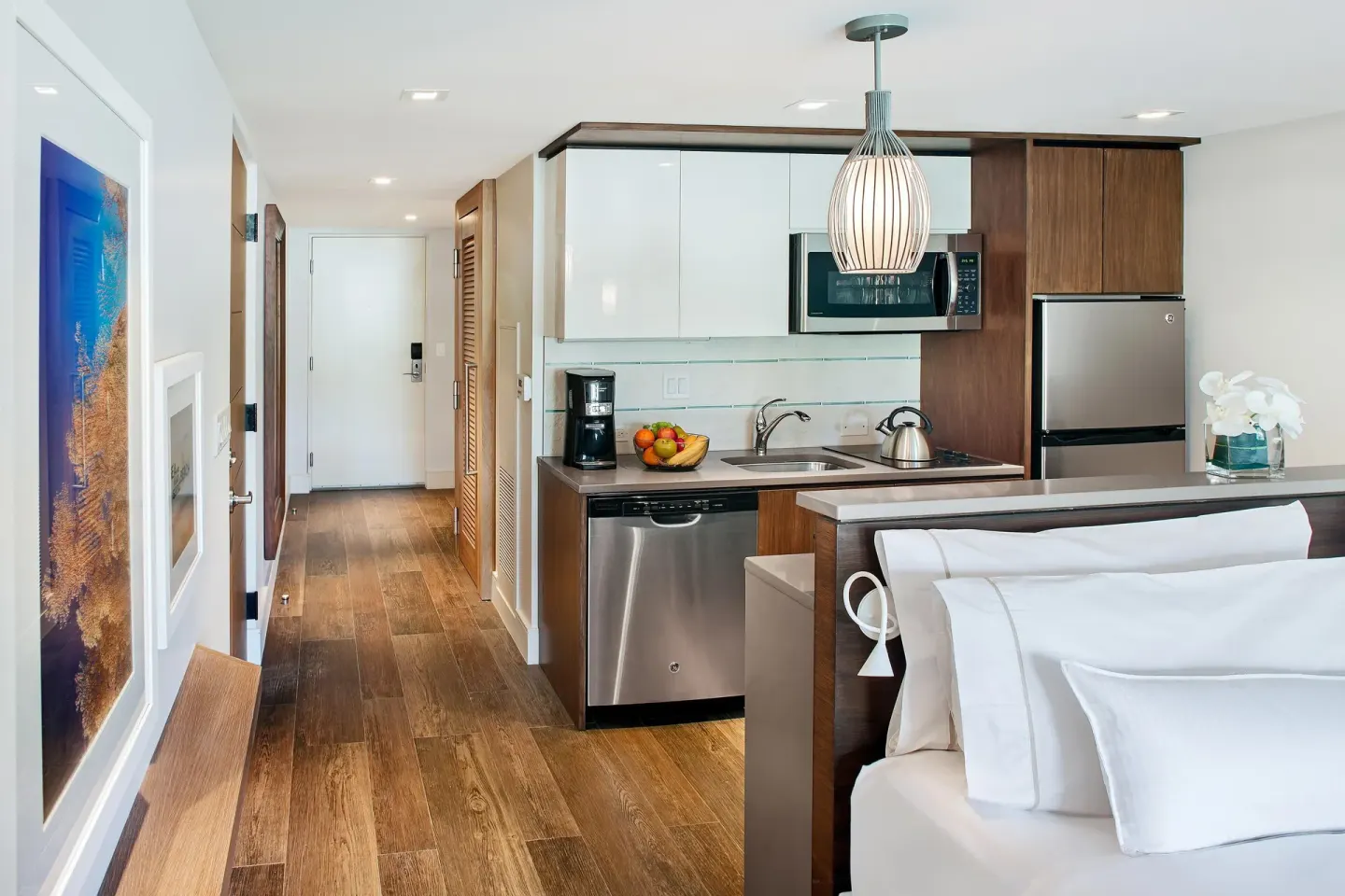 Studio king bed and kitchenette with wood floors at The Westin St. John Resort Villas.