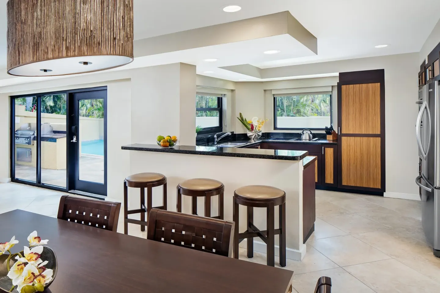 Villa kitchen and dining area beside glass doors at The Westin St. John Resort Villas.