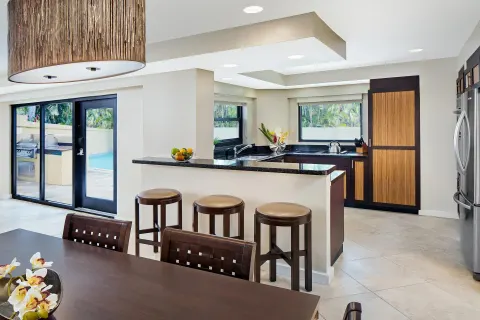 Villa kitchen and dining area beside glass doors at The Westin St. John Resort Villas.