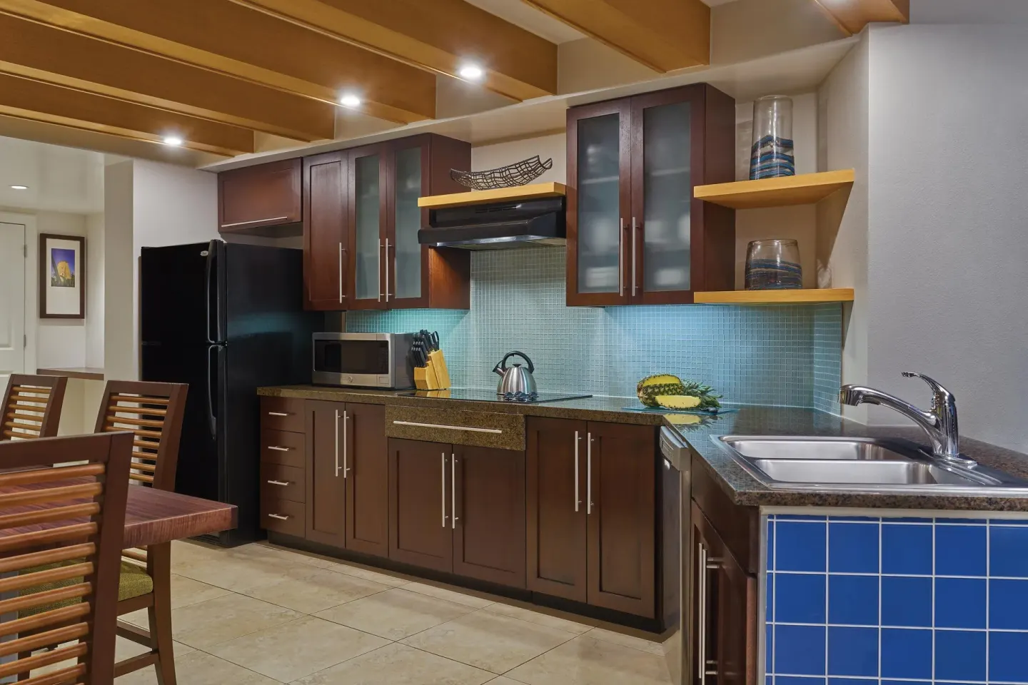Villa kitchen with dark cabinets and blue-tile sink counter at The Westin St. John Resort Villas.