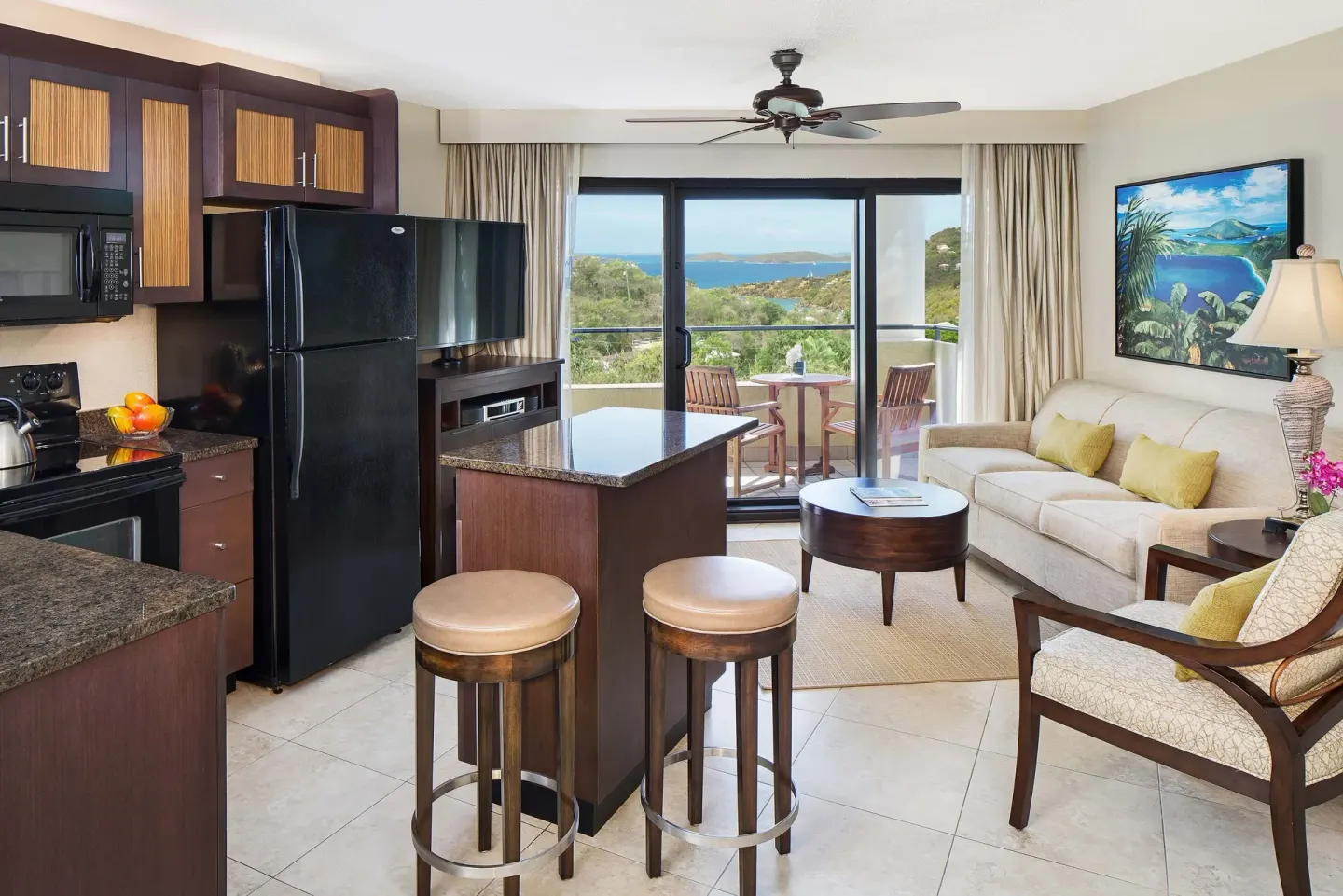 Villa living area with kitchenette, balcony, and bay view at The Westin St. John Resort Villas.