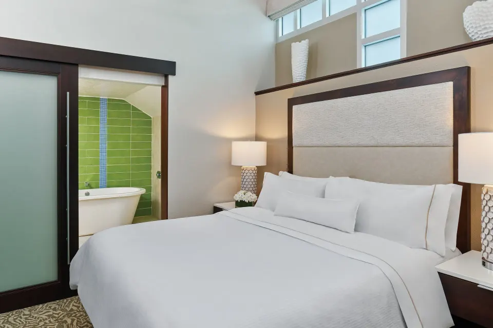 Loft bedroom with king bed and open bathtub area at The Westin St. John Resort Villas.