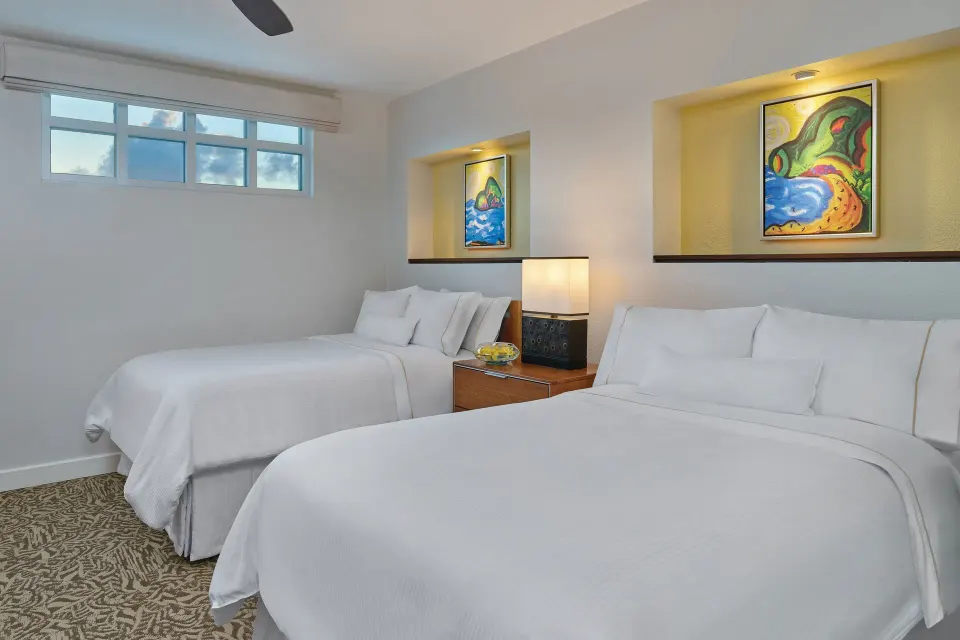 Loft bedroom with two white beds and colorful wall art at The Westin St. John Resort Villas.