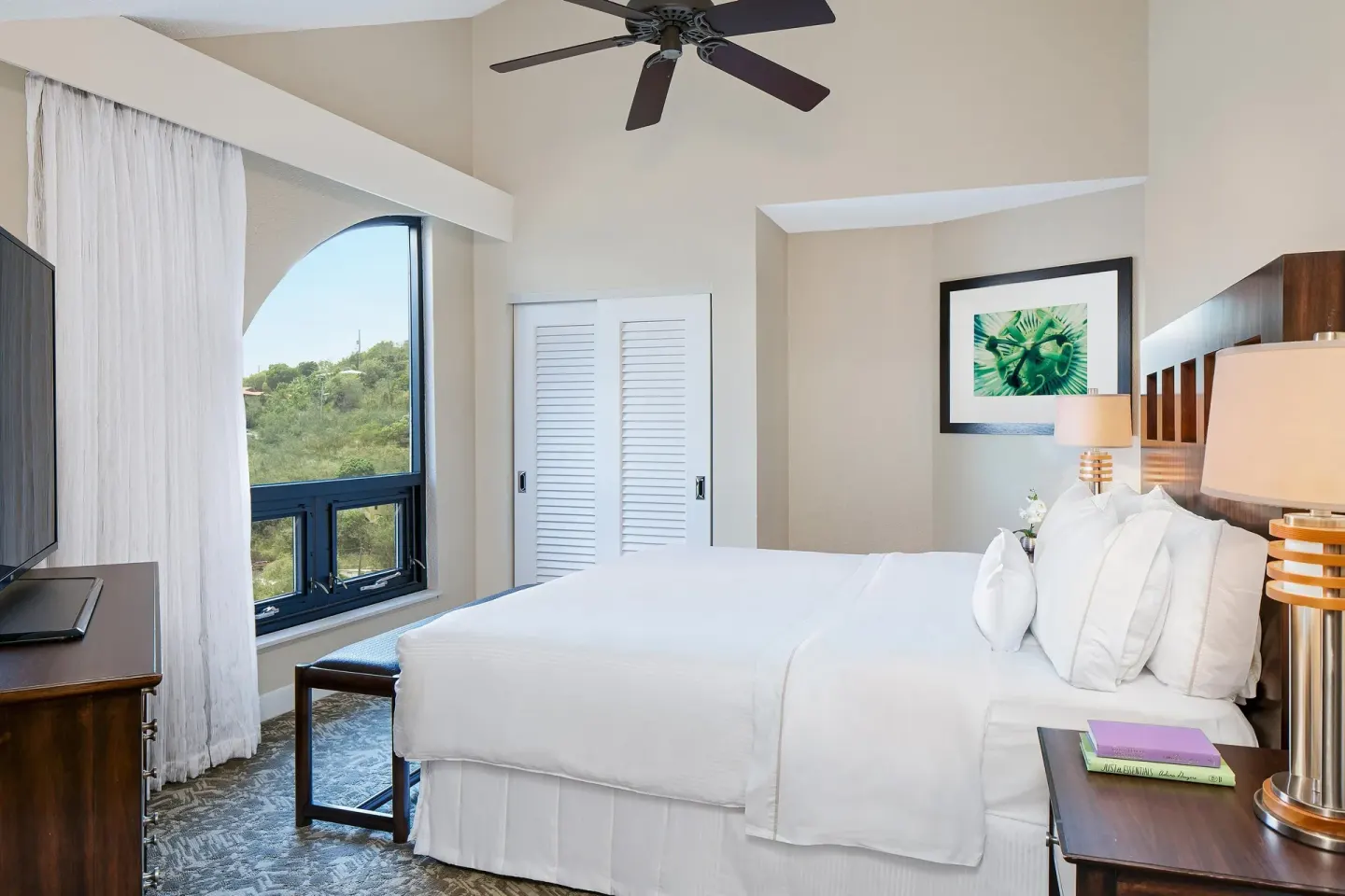 Two-bedroom resort-view villa bedroom with king bed and arched window at The Westin St. John Resort Villas.