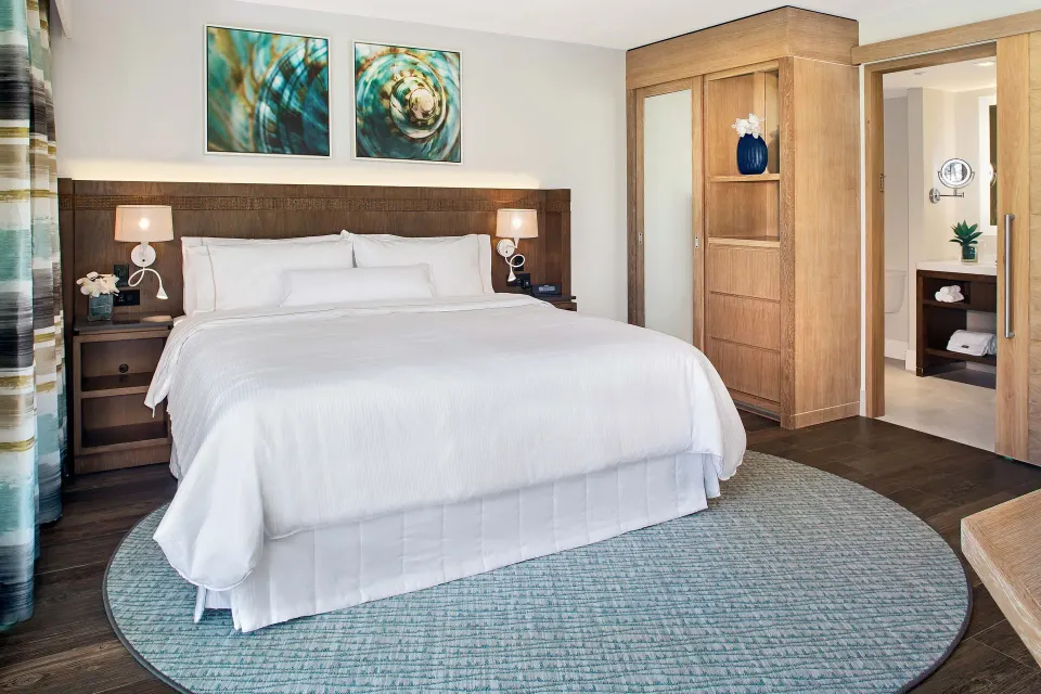 King bed and open bathroom doorway in a villa bedroom at The Westin St. John Resort Villas.