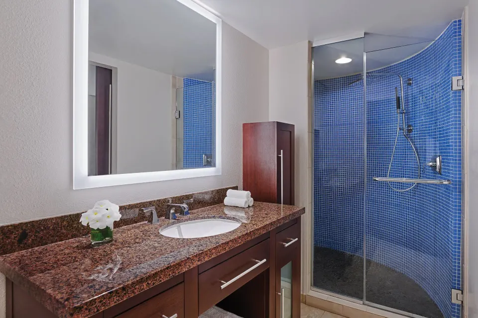 Villa bathroom vanity and blue-tile glass shower at The Westin St. John Resort Villas.
