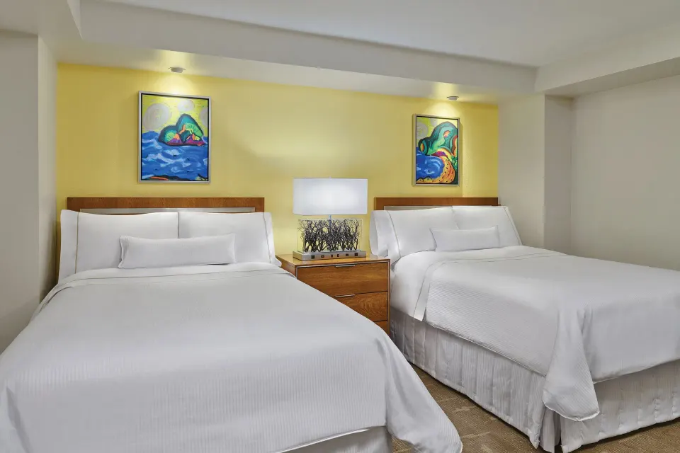 Two-bed villa bedroom with yellow accent wall at The Westin St. John Resort Villas.