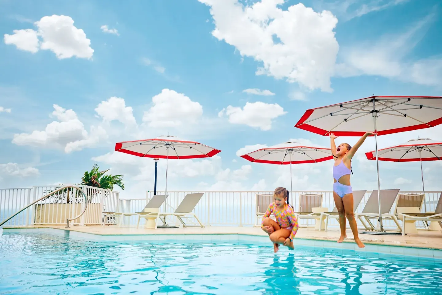 Children jumping into the pool at The Westin St. Thomas Beach Resort & Spa.