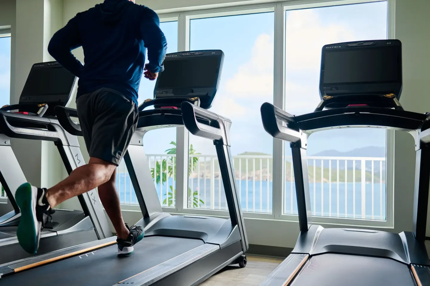Runner on a treadmill with ocean views at The Westin St. Thomas Beach Resort & Spa.