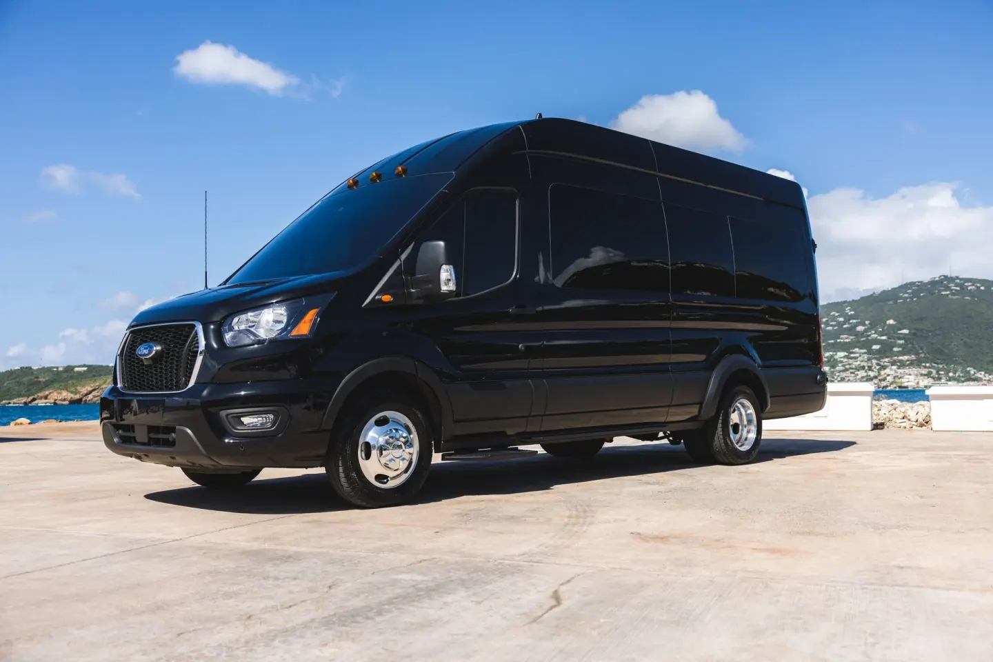 Black passenger van parked by the water at The Westin St. Thomas Beach Resort & Spa.