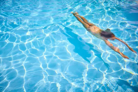 Swimmer gliding underwater in the pool at The Westin St. Thomas Beach Resort & Spa.