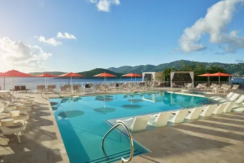 Daytime pool with lounge chairs and bay views at The Westin St. Thomas Beach Resort & Spa.