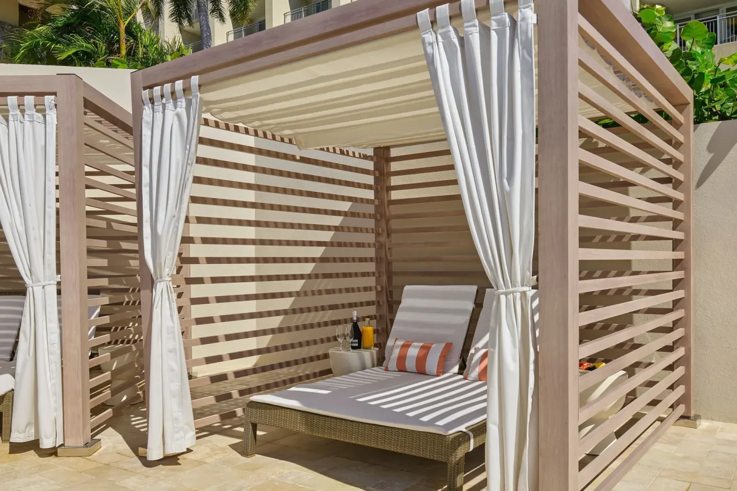 Poolside cabana with cushioned lounger at The Westin St. Thomas Beach Resort & Spa.