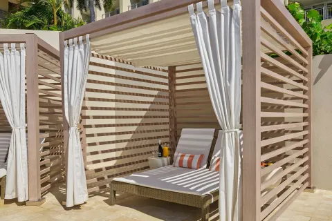Poolside cabana with cushioned lounger at The Westin St. Thomas Beach Resort & Spa.