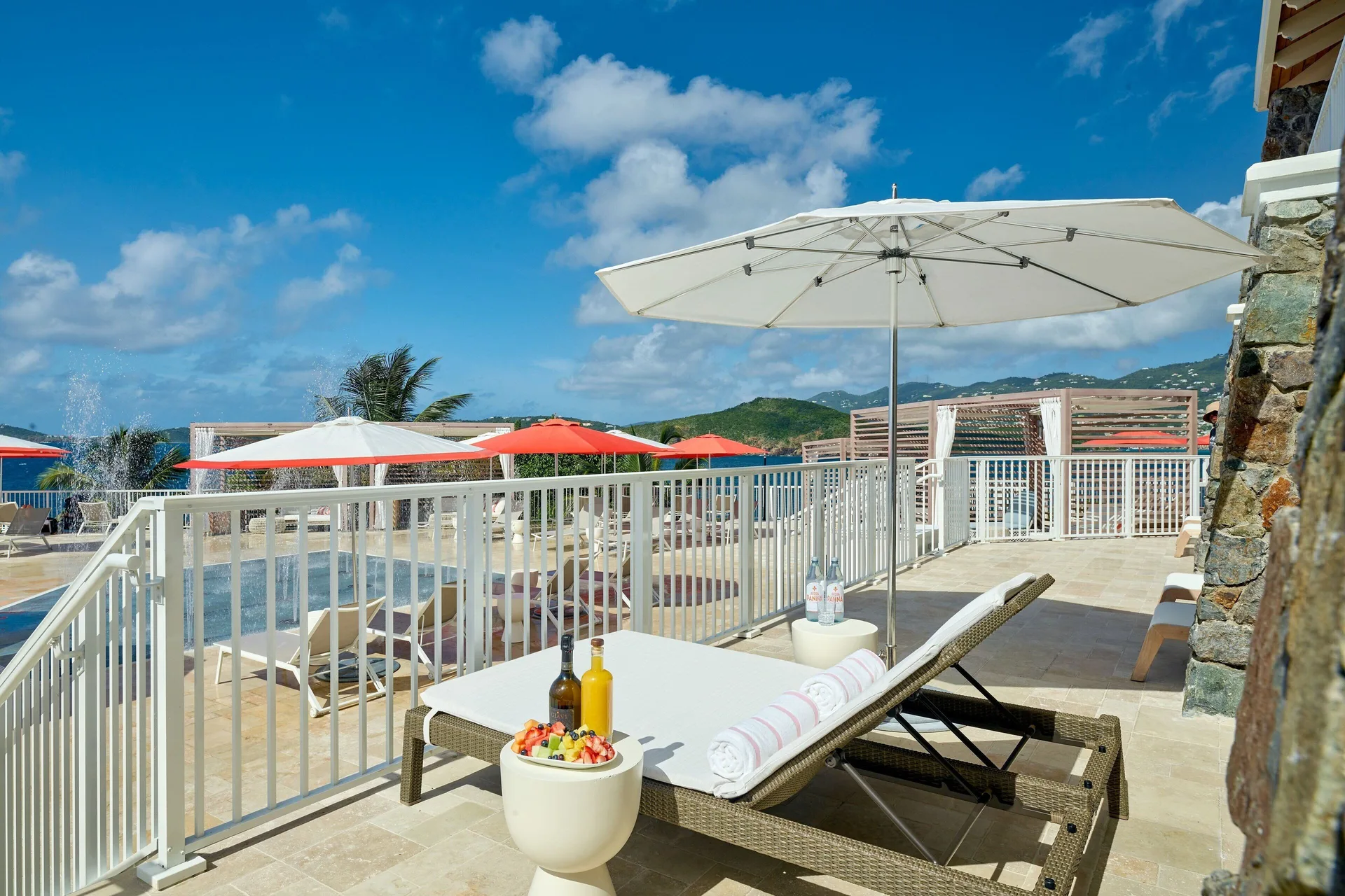Poolside lounge chair with umbrella at The Westin St. Thomas Beach Resort & Spa.